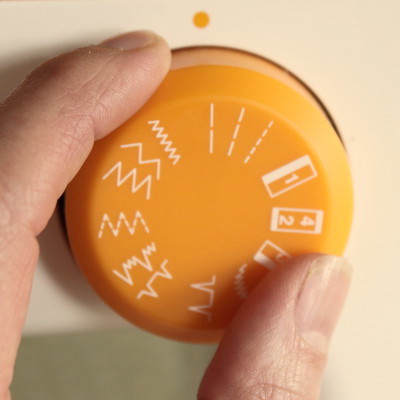 Sewing machine settings dial
